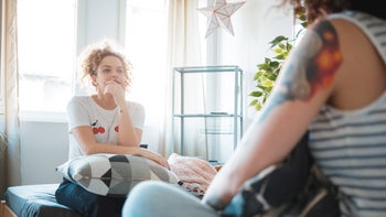 Alcohol use disorder: friends talking in bedroom 1154918065