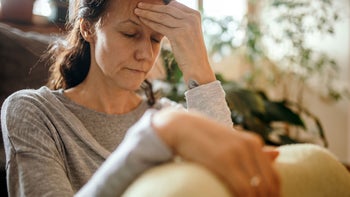 hypertension: woman suffering from headache 1210749087