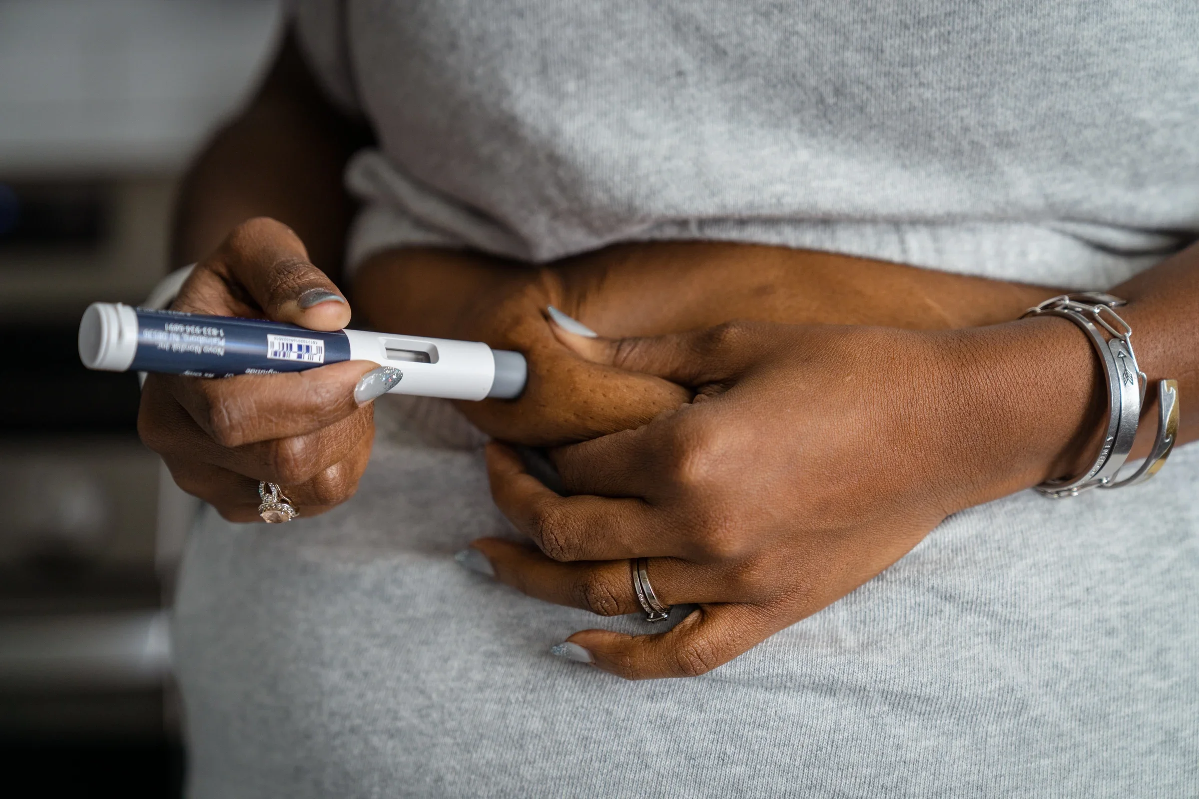Closeup of Arelis Latorella taking Wegovy injection in stomach.