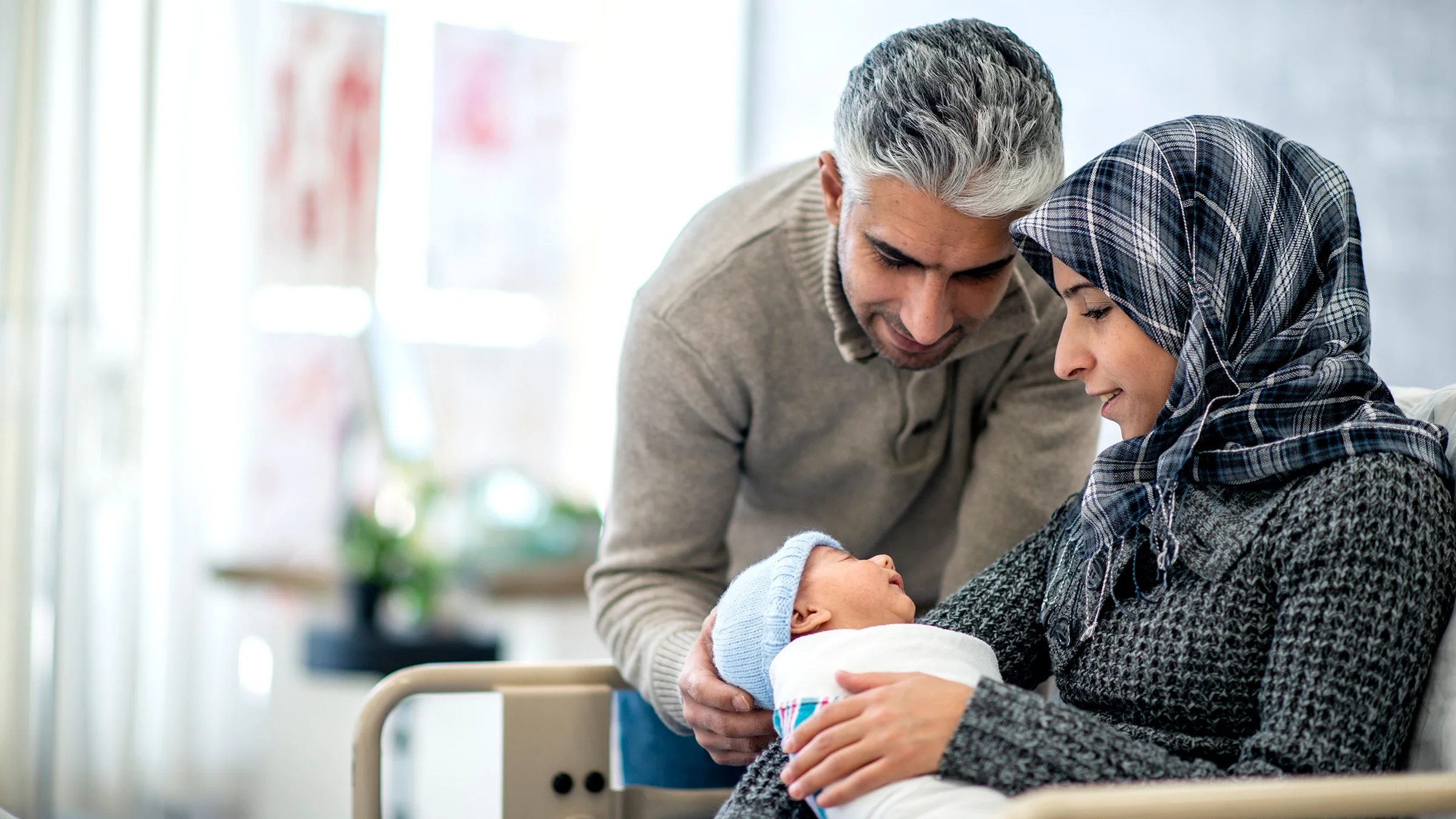 New parents holding their newborn