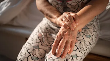 Cropped image of someone with rheumatoid arthritis massing their wrist.
Johnce/E+ via Getty Images  