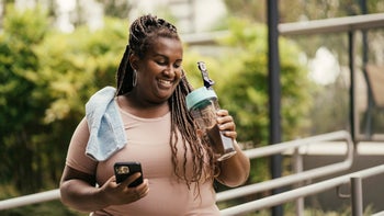 Weight loss: woman hydrating after a workout 2170544682