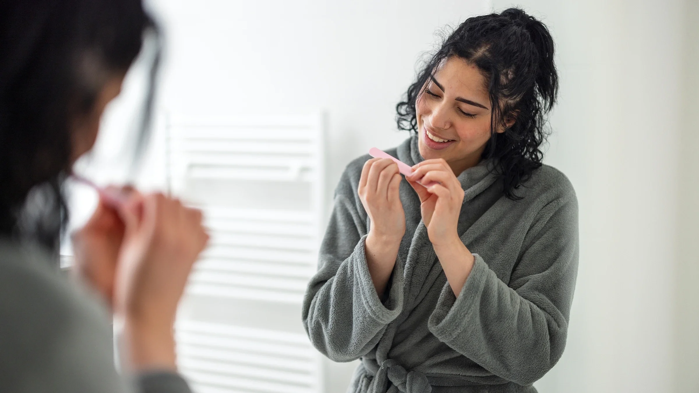 Woman filing her nails.