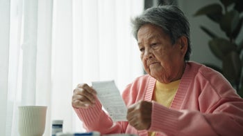 Research: senior woman reading medical instructions 2161658680