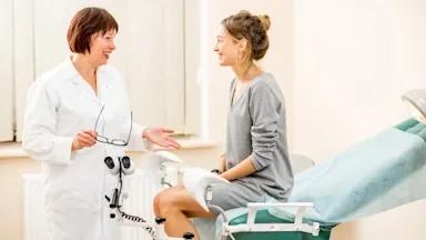 Young woman at the gynecologist in the exam room.
RossHelen/iStock via Getty Images