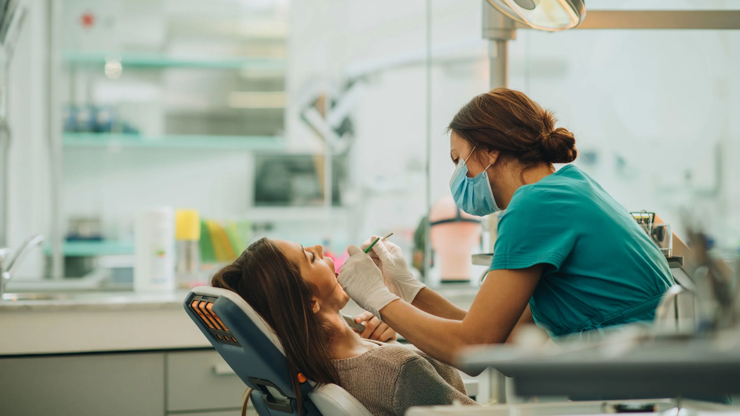 Dentist examining woman's teeth.