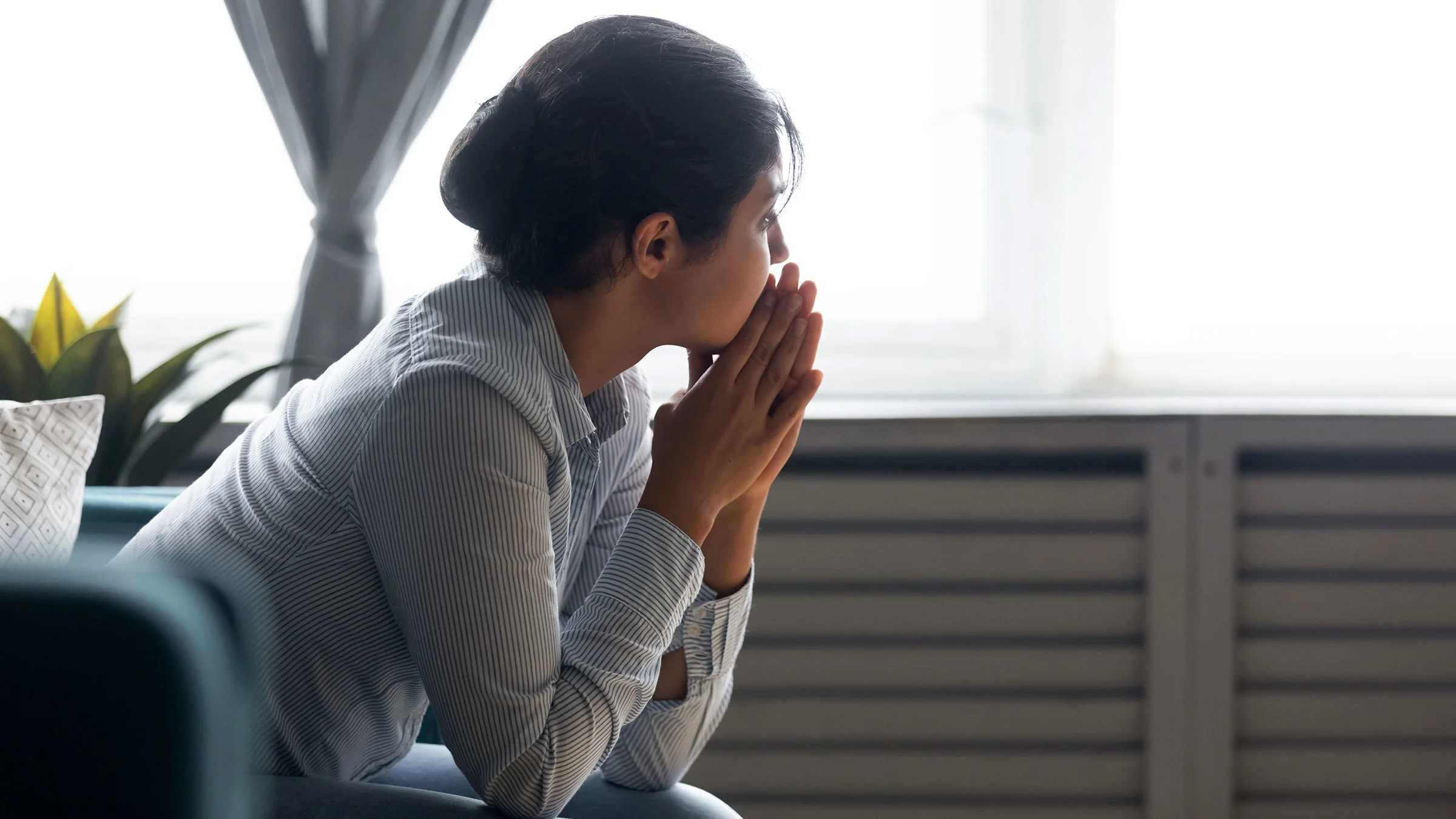 A woman is upset at home.