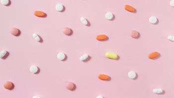 Health: Side effects: pills on pink background 1179963346