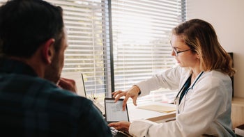 medicare: doctor discussing results with patient 1128194432