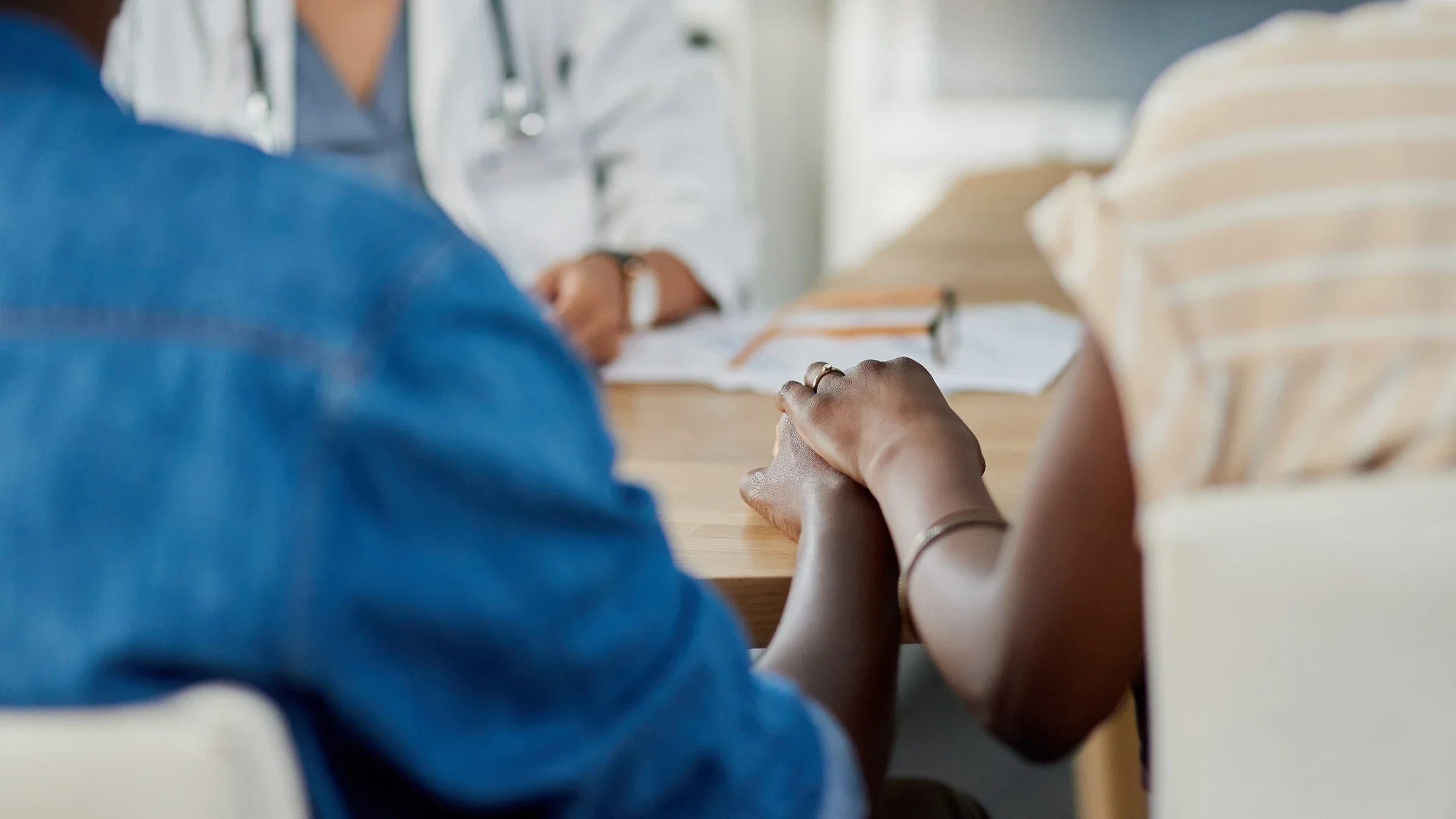 A close-up of a couple holding hands at the doctor's office waiting for results.
Adene Sanchez/E+ via Getty Images