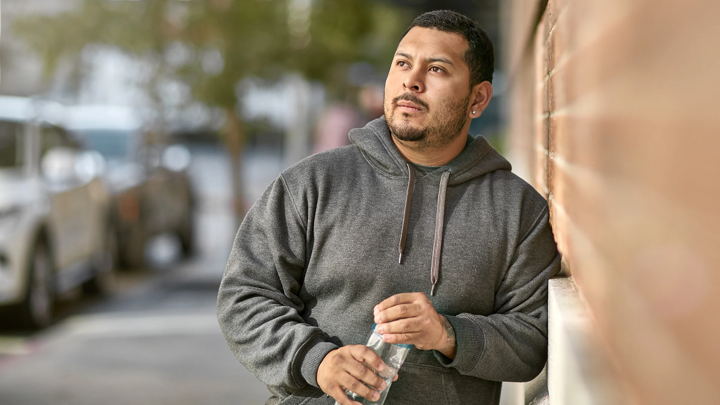 A man holds a water bottle.
