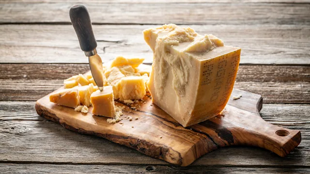 diet-nutrition: parmesan reggiano cheese on a cutting board 1203727665