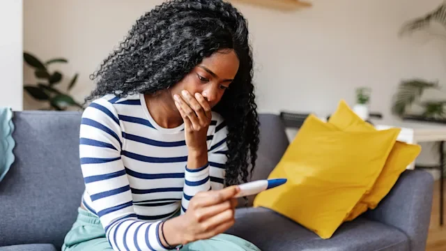 Fertility: woman with pregnancy test 2253732501