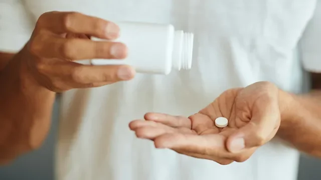 Health: Finasteride: pouring one pill into hand 1352734441