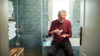 Health: Coreg: senior man taking medication 1486331433