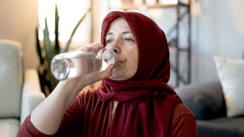 Hemorrhoids: woman drinking water 2153391283