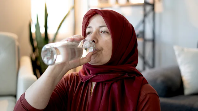 Hemorrhoids: woman drinking water 2153391283