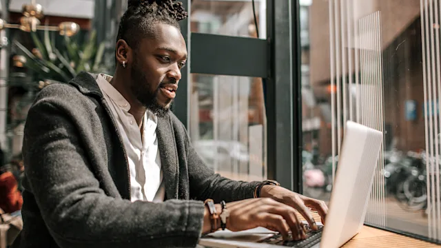 Health: Digital health: man typing on a laptop 1488348444
