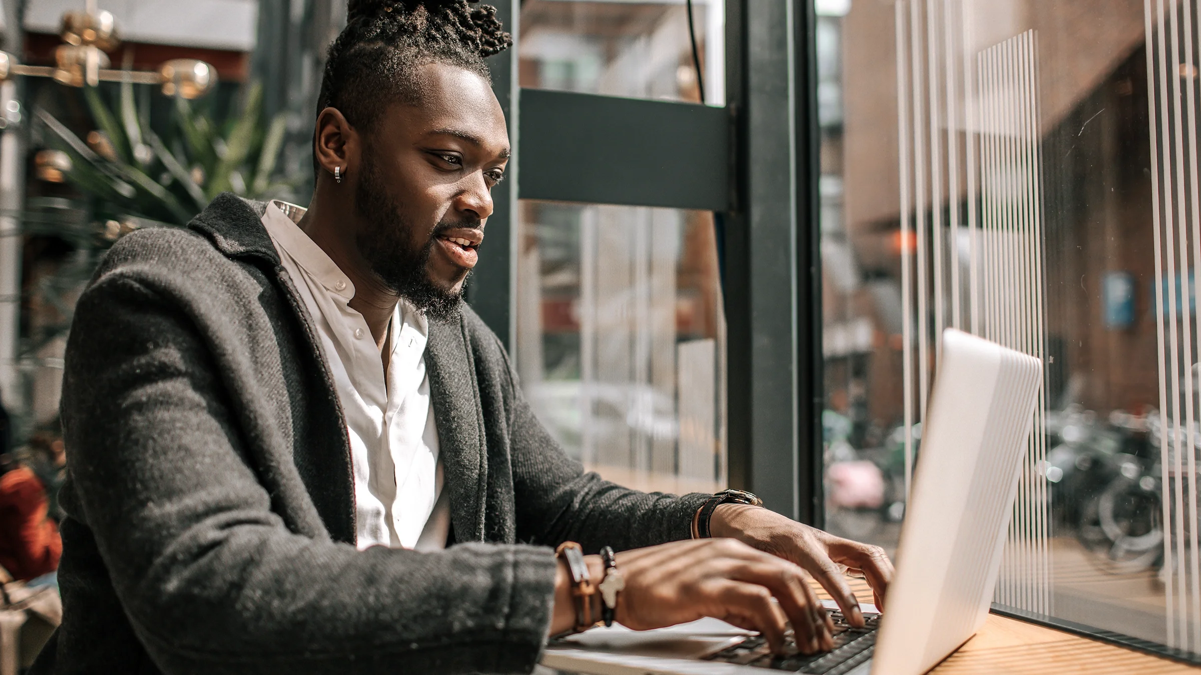 A man is typing on a laptop.