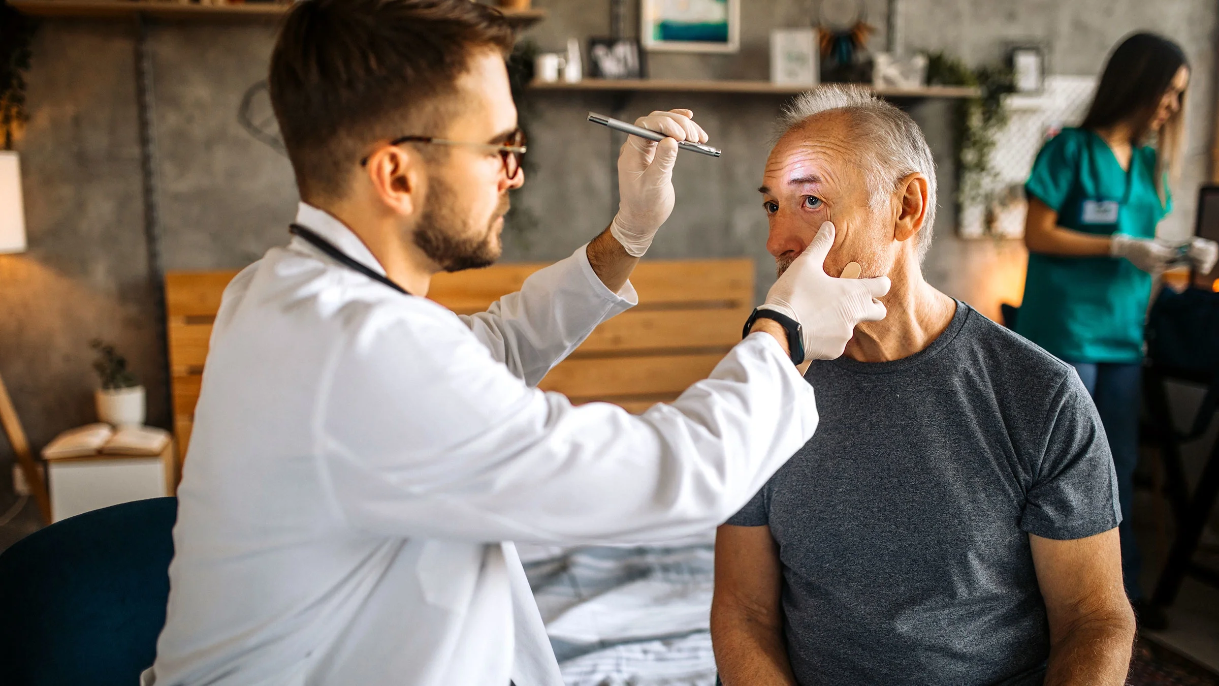 A healthcare professional examines a person’s eye. People can experience blepharitis, when the eyelids get inflamed. This may be caused by allergies, infections, and makeup.