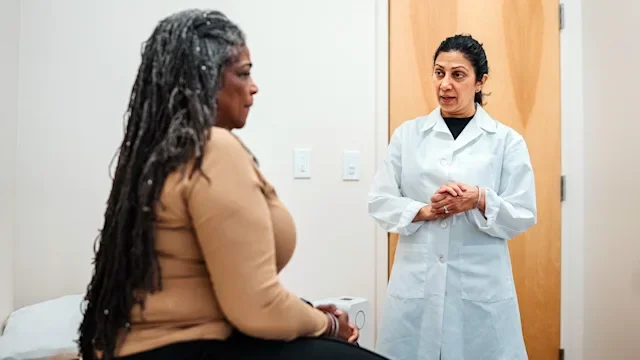 HCP: woman at medical appointment 2209671472