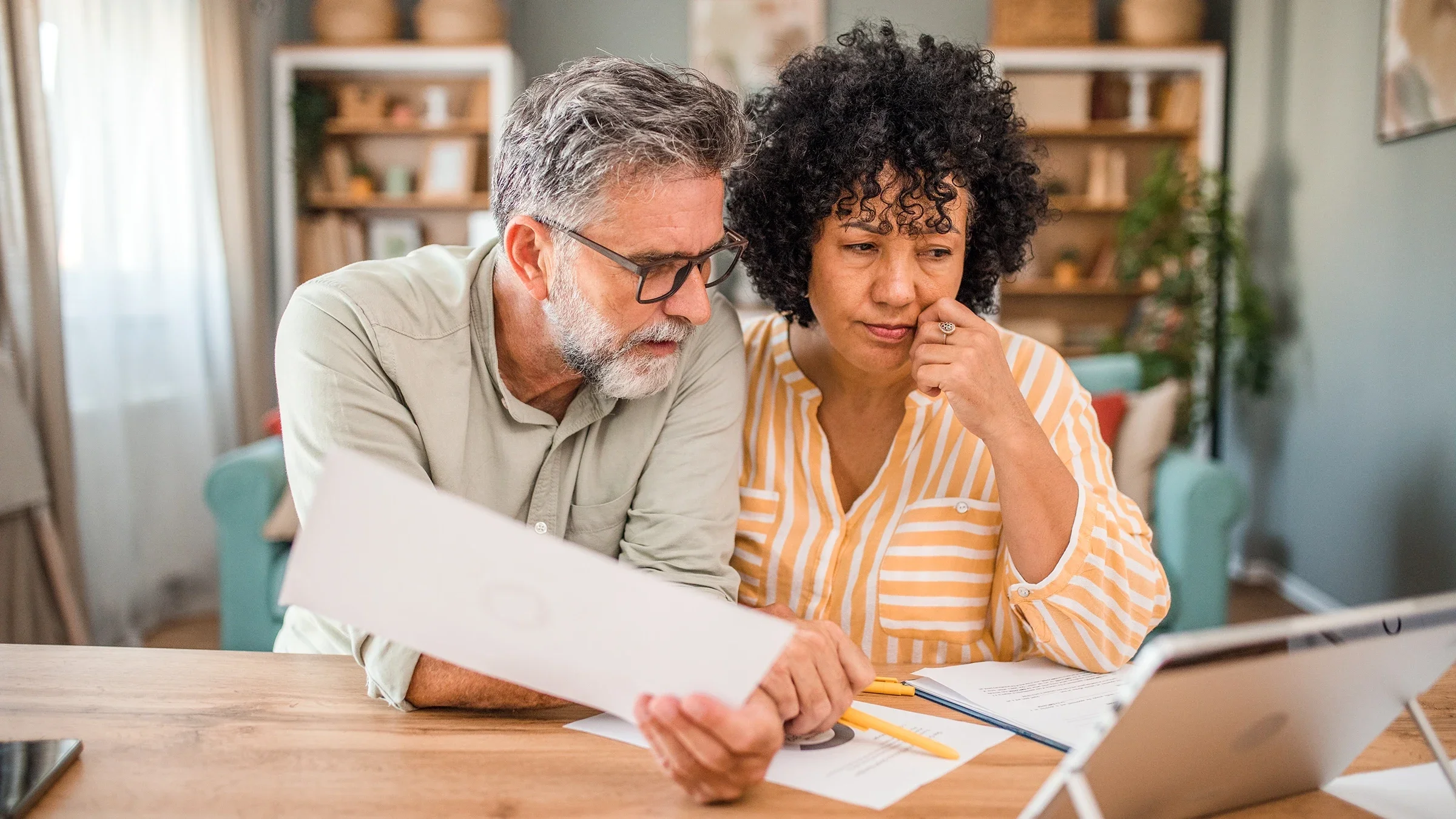 Couple reviewing paperwork at home
DekiArt/iStock via Getty Images Plus