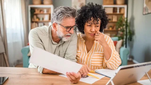 Personal Finance: couple reviewing paperwork 2193142113