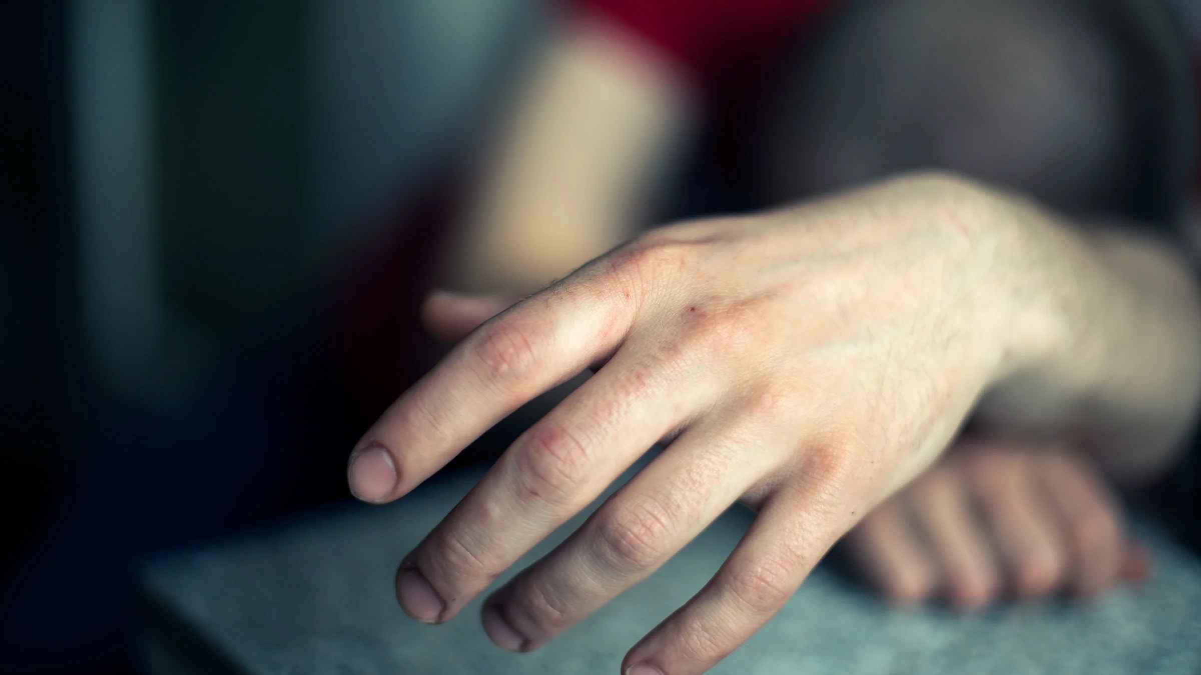 Close-up hand of unrecognizable person passed out
