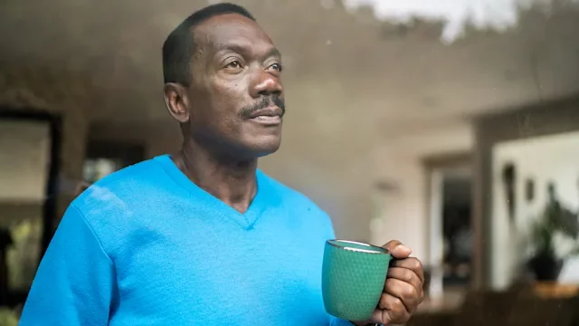 Health: Mental health: older man drinking coffee looking out window 1334849440