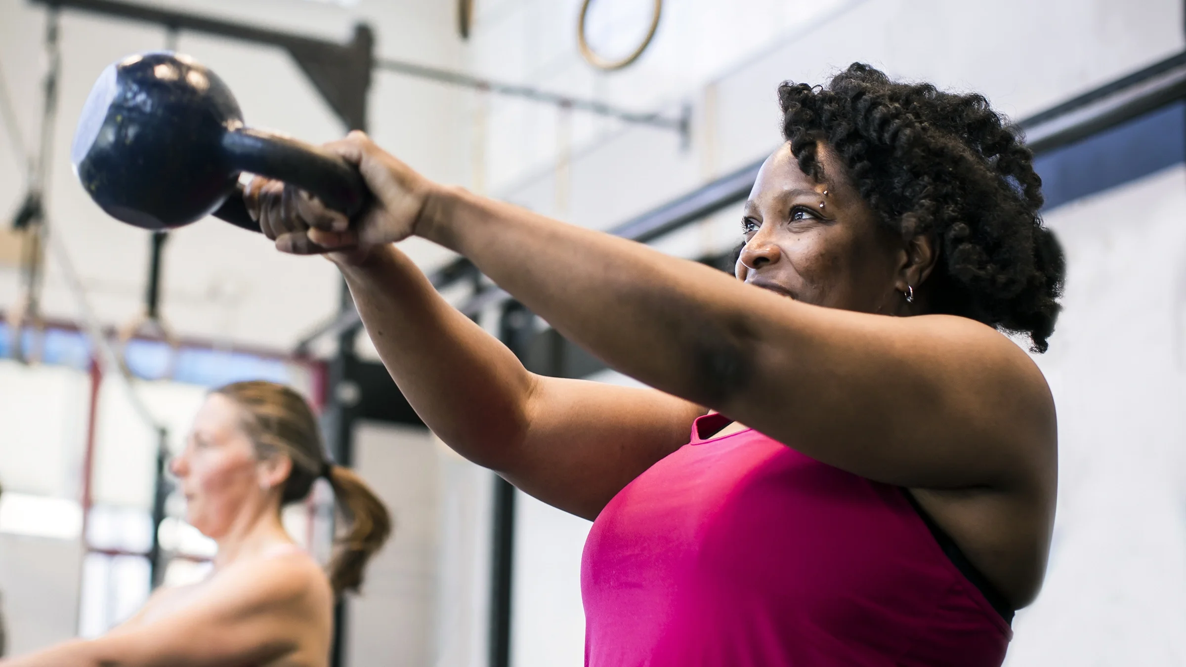 A woman works out with a kettlebell.