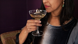 A woman is holding a champagne glass in a close-up.
Jeanny Tsai/iStock via Getty Images Plus