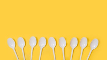 Mental health: Spoon theory: white plastic spoons on yellow background-1225517308