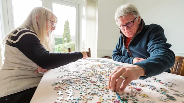 senior couple doing puzzles 1295780712