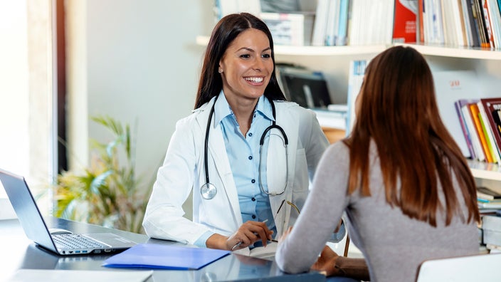 A medical professional consults with a patient.