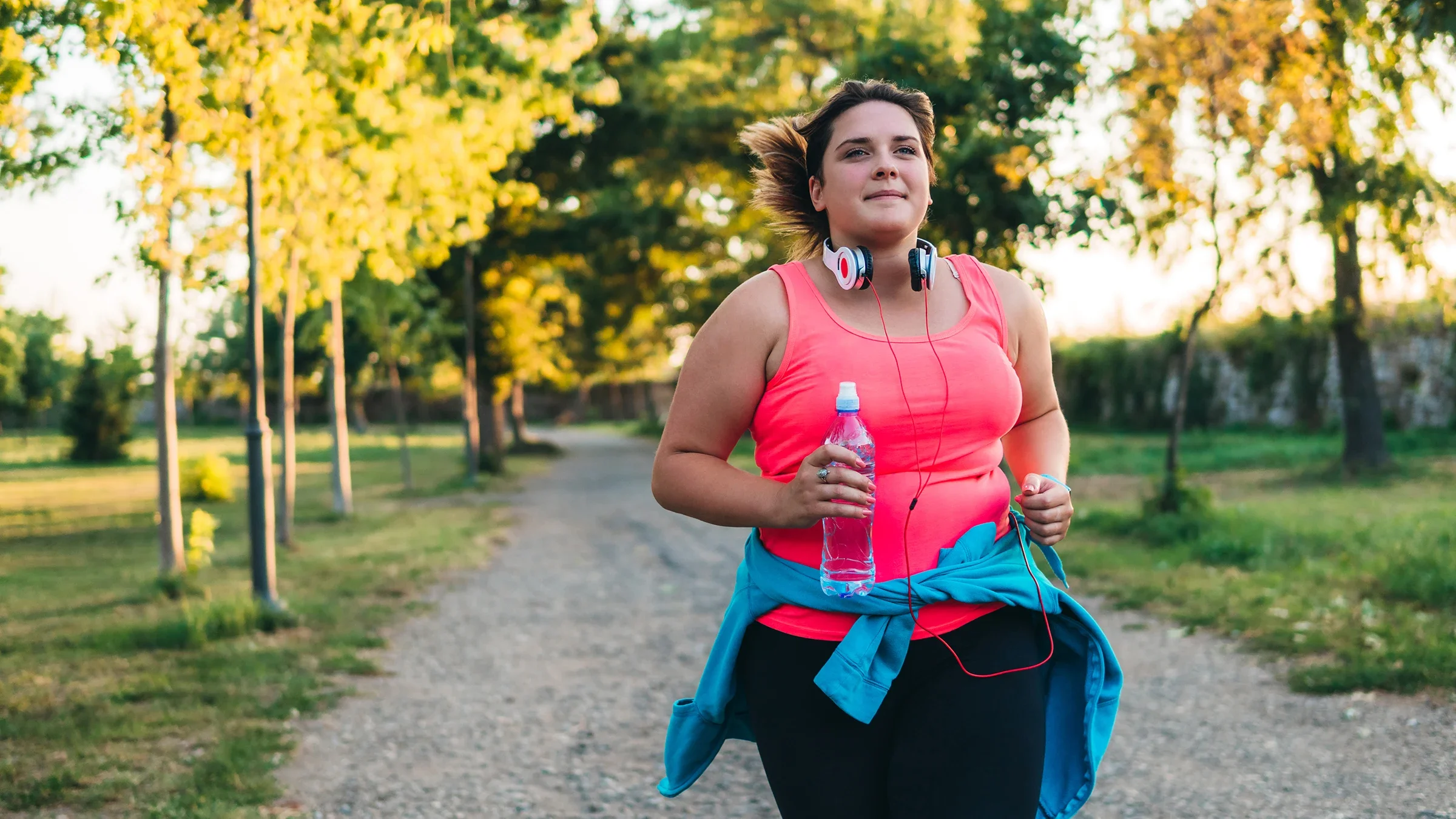 Movement Exercise: woman running in a park 1192844822