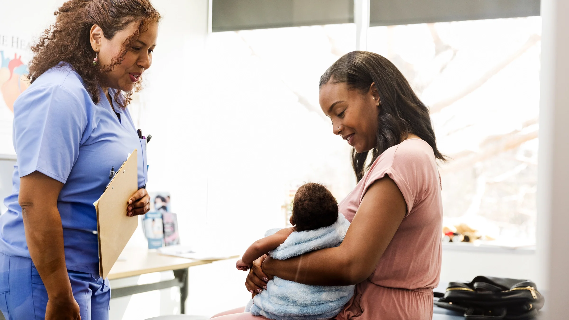A mother brings her infant child to a medical appointment.