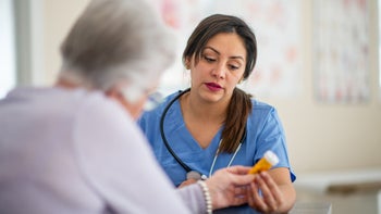 HCP: senior woman at medical appointment 2156971015