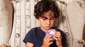 advair: boy using asthma inhaler 1254636749