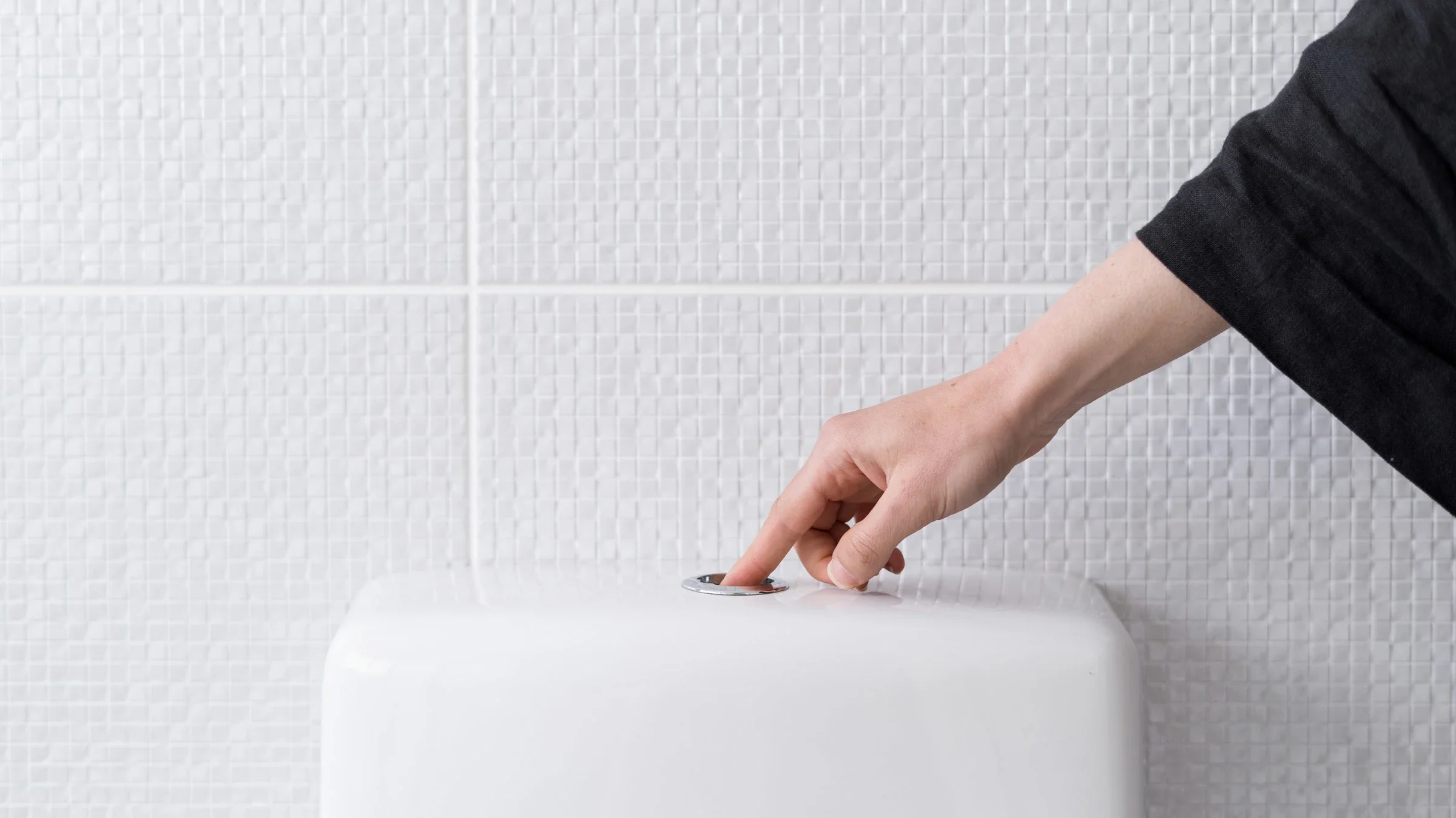 A hand flushing a toilet.
brizmaker/iStock via Getty Images Plus  