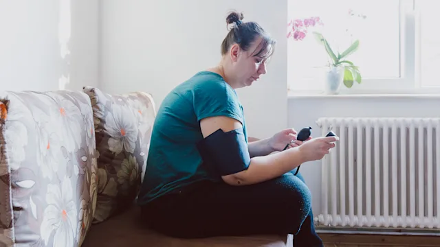 Hypertension: woman checking blood pressure 1370925760