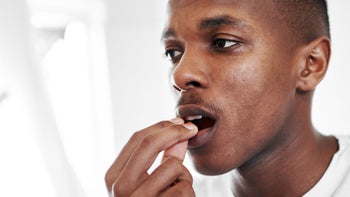ADHD: adderall: close-up taking pill 1187064892