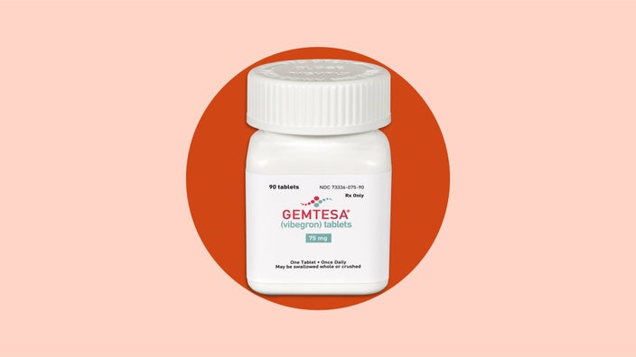 Bottle of Gemtesa medication on red background.