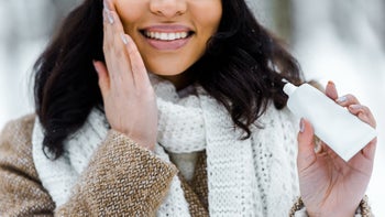 Dermatology: woman applying face cream 1094451278