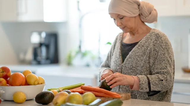 Cancer: Food during chemotherapy: cancer patient cutting veggies 1370802794