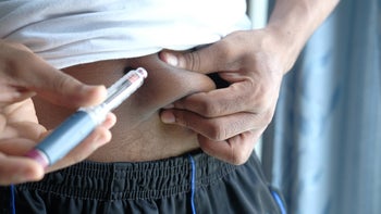 Health: GLP-1 Agonists: man closeup insulin injection stomach 1326112164