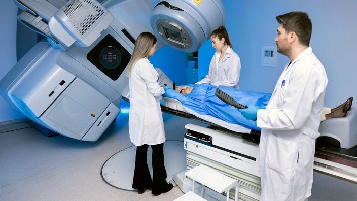 A woman is undergoing radiation therapy.