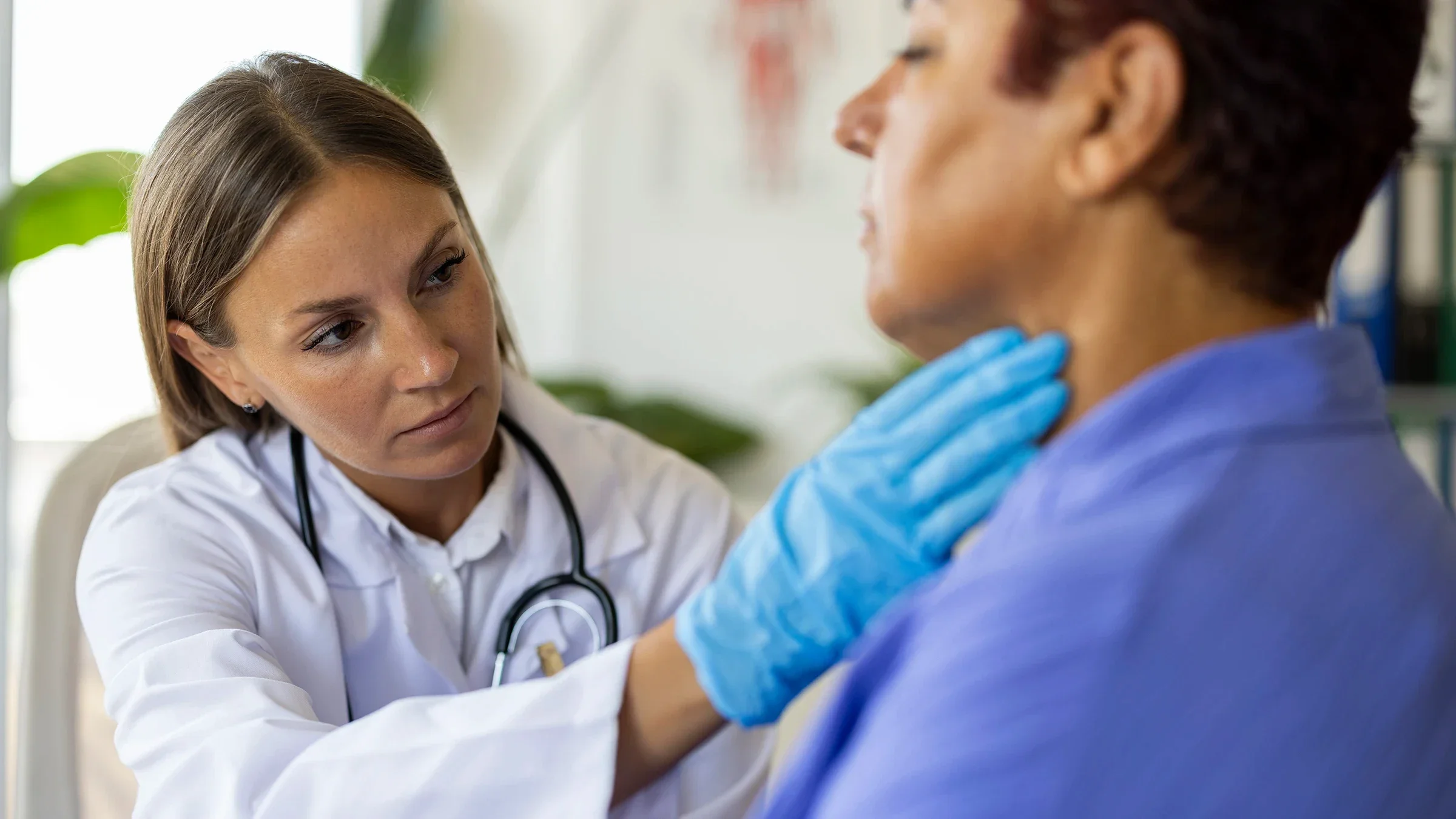 A healthcare professional is checking a person’s thyroid.
bymuratdeniz/iStock via Getty Images Plus