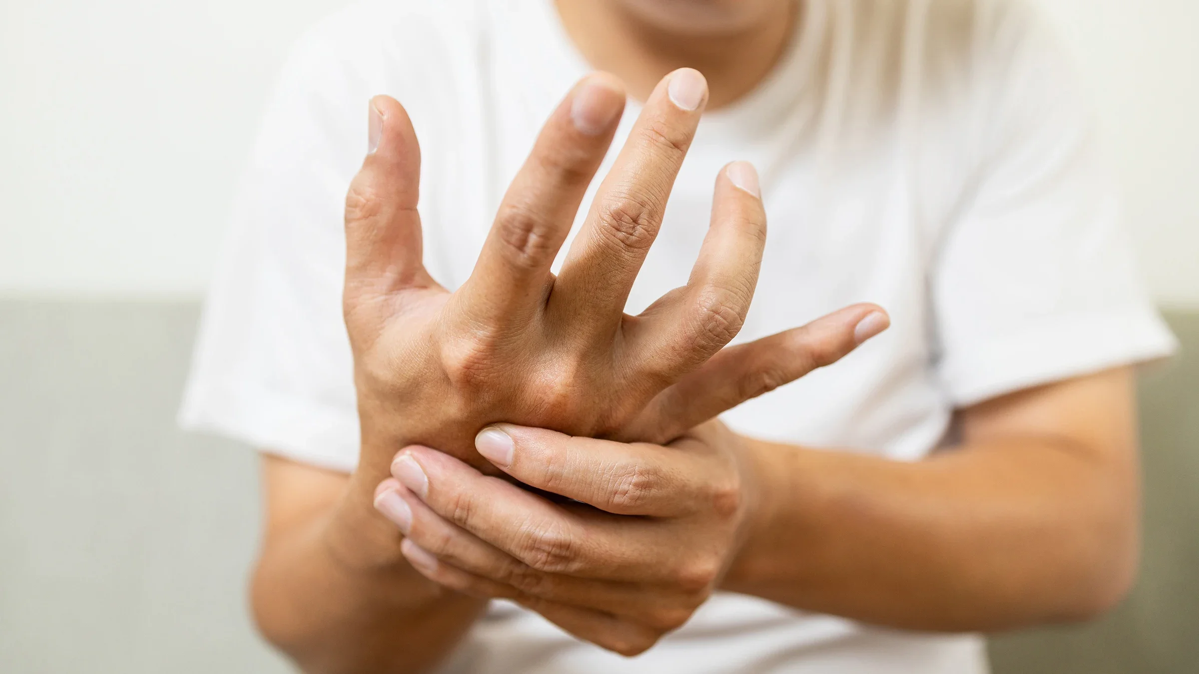 A close-up on the hands of a person with early-stage Parkinson's.
Satjawat Boontanataweepol/iStock via Getty Images