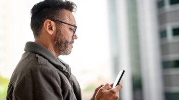 Mental-health: man texting on mobile phone 1060895682