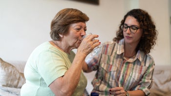 medication-basics: senior woman takes medication 1089349228